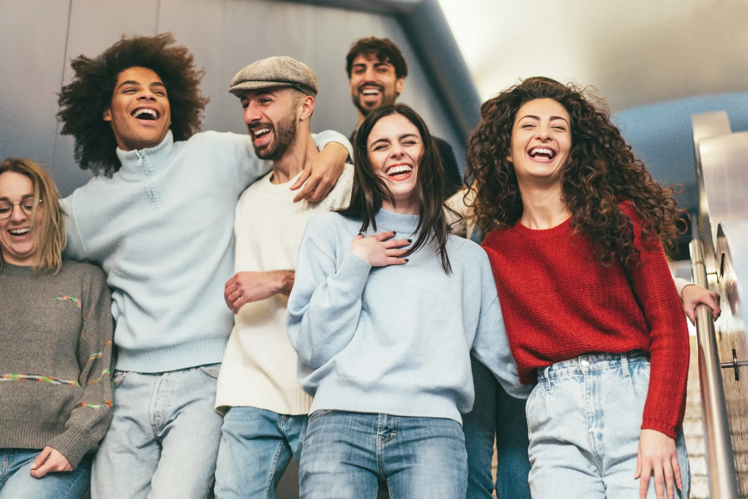 Happy friends having fun inside underground metropolitan station Soft focus on right girl face
